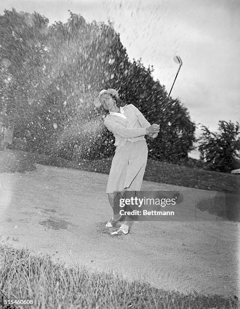 Mrs. George Zaharias sloshes up some of the green in this mighty drive. A former Olympic star, Mrs. Zaharias carded an impressive score of 77 to take...