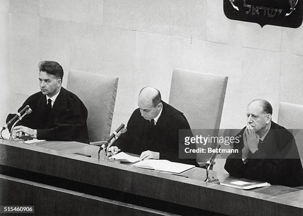 Adolf Eichmann listens in the prisoner's dock at the left, as presiding Judge Moishe Landau, , gives the verdict, at the conclusion of his trial. The...