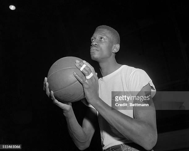 Bill Russell, San Francisco Basketball player holding ball.