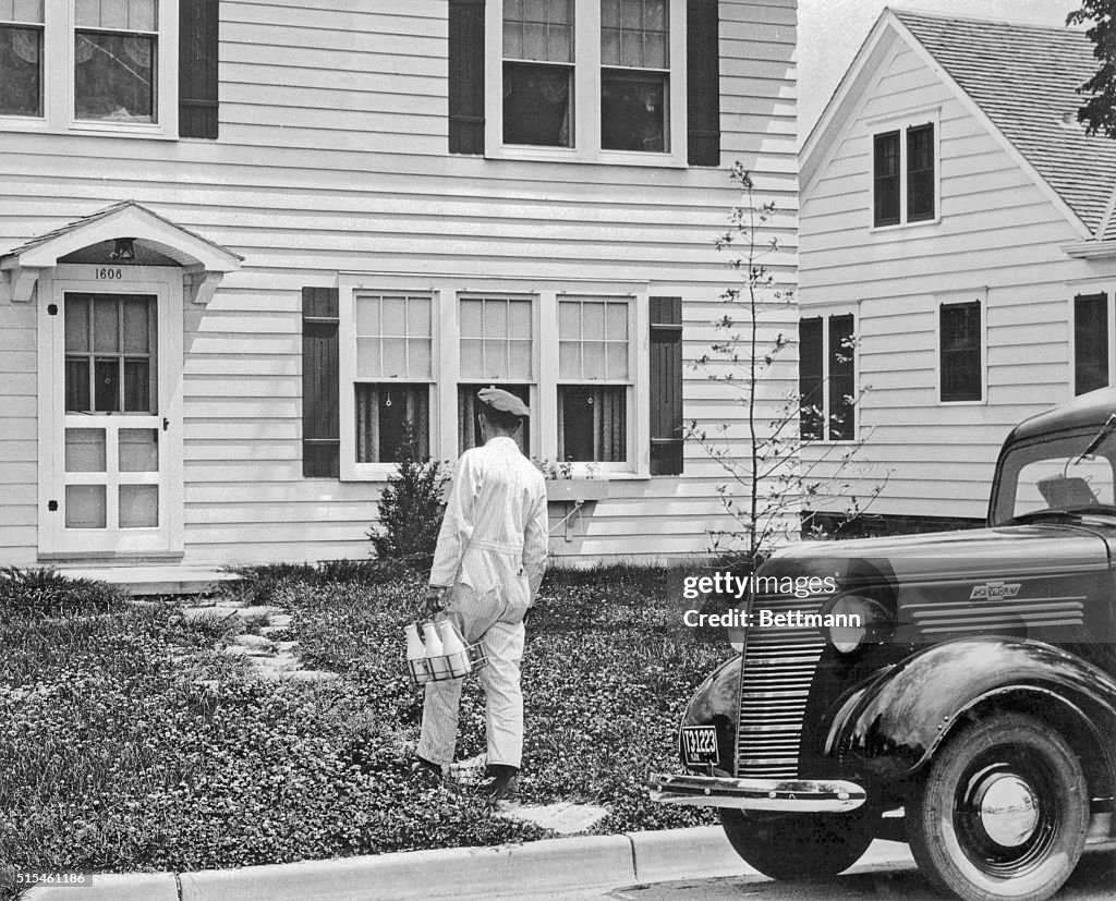 Milkman Delivering Milk to a House
