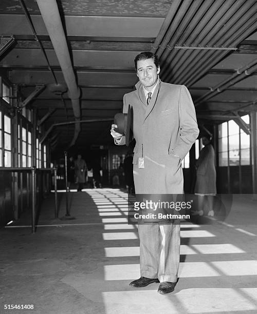 New York, NY-ORIGINAL CAPTION READS: Errol Flynn screen idol for girls across the nation, arrived in New York today at LaGuardia Airport, from Mexico...