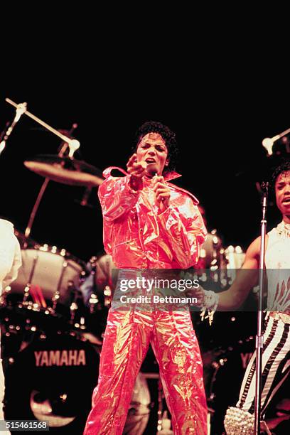 Michael Jackson performing on stage at Arrowhead Stadium with his brothers while on their "Victory Tour."