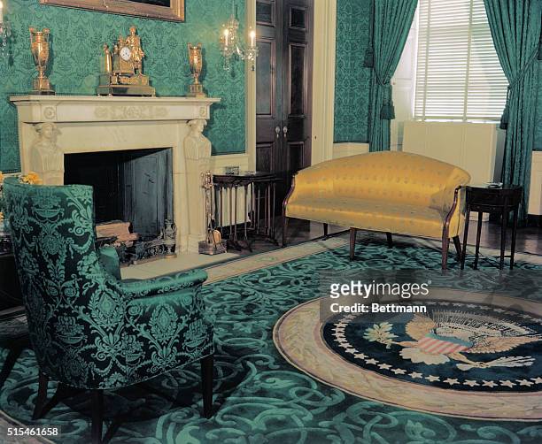 The interior of the White House Green Room is shown, it is located on the first floor with the Presidential Seal.