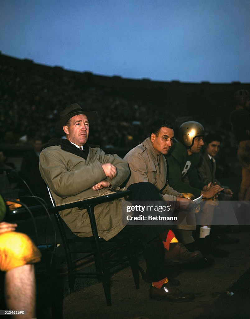 Coach Frank Leahy Watching Game with Players