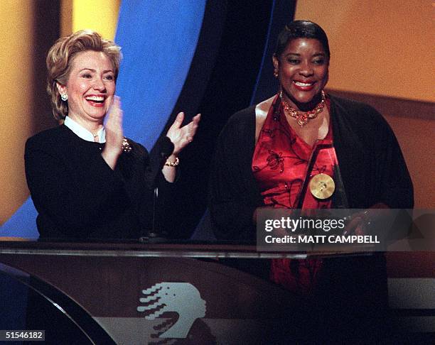 First Lady Hillary Rodham Clinton applauds as she and actress Loretta Devine introduce Mayor Emma Gresham for an Essence Award during the 2000...