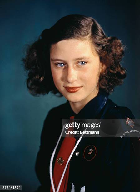 Princess Margaret Rose wears a uniform of the Girl Guides, an organization in which she is very active, in this photo. The princess will be fourteen...