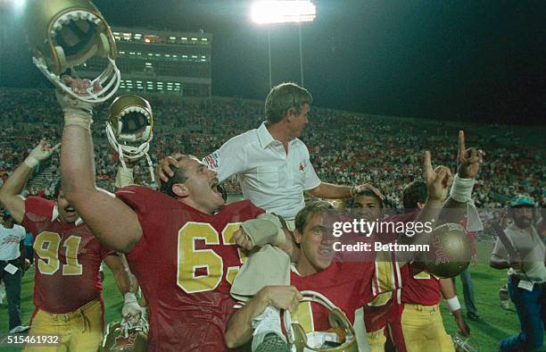 Tampa, Fla.: Philadelphia star coach Jim Mora, on the shoulders of some of the victorious USFL players, celebrates their victory over the Arizona...
