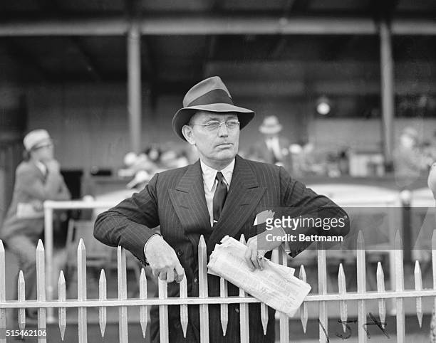 Louisville, KY- Damon Runyon, ace relator of epics of the track and outstanding story teller of the "Undercrust" of the sport of kings, leans over...