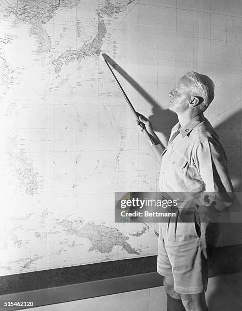Guam- Fleet Admiral Chester W. Nimitz, Commander in Chief of the Pacific Fleet and Pacific Ocean Areas, points to Tokyo on chart in his headquarters...