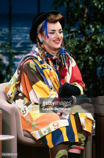 British pop musician Boy George, of the group Culture Club, smiles while Joan Rivers interviews him on the Joan Rivers Show. He is shown alone,...