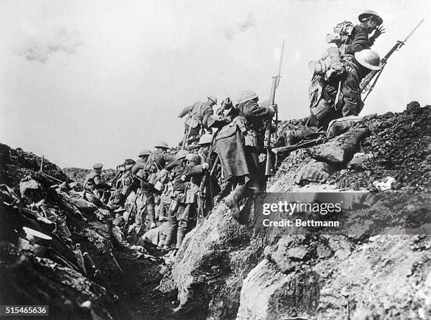 Company of Canadian soldiers go "over the top" from a World War I trench.