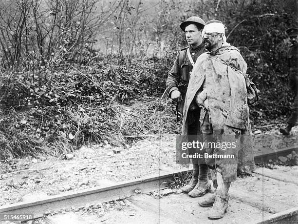 This German went willingly into battle. This is how he came out. An American of the 39th division is taking the badly wounded man to rear after he...