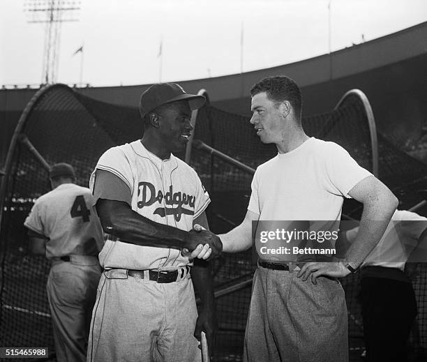 Ebbets Field, Dodgers vs. Giants. Jackie Robinson and Gil McDougald, third baseman for the New York Yankees are shown before game.