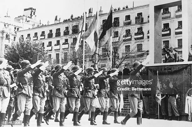 Madrid, Spain: Spanish infantrymen giving the Fascist salute as they march past Generalissimo Franco in Madrid on the first anniversary of the...