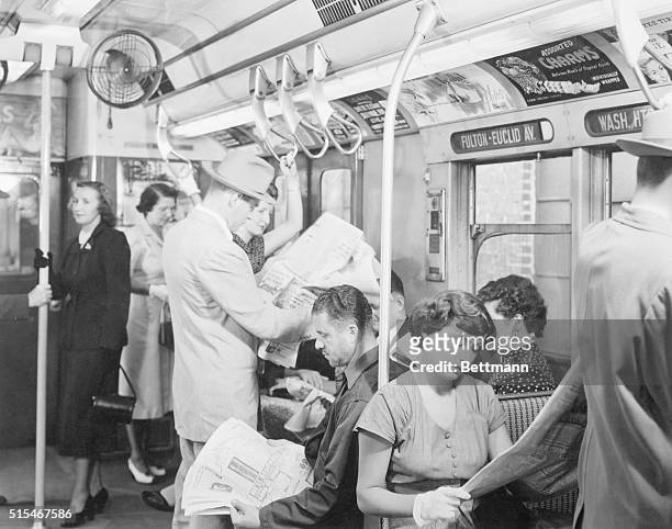 Interior view of New York City subway car with passengers; subway line going from Washington Hgts. To Fulton & Euclid Ave. Ca. 1950s photo.