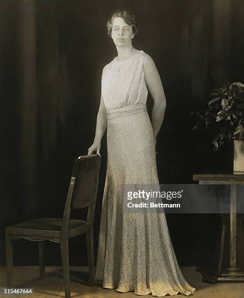 Mrs. Roosevelt posing in the gown she wore at the Inaugural Ball. It is made of silver blue lame.