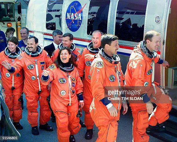Space Shuttle Mission STS-101 Mission Specialist Mary Ellen Weber points to a sign joking about wind condititions joined by Commander James Halsell ,...