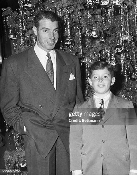 Joe DiMaggio and Son in Reno. Reno, Nevada: Christmas visitors in Reno are Joe DiMaggio and Joe, Jr., standing beside the Christmas tree at the Mapes...