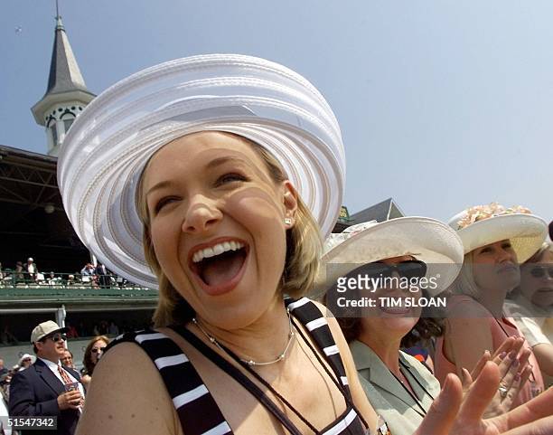 Lisa Hunter, Alexa Gromko, and Melissa MacBride all from Lexington, KY watch the first race 06 May, 2000 at Churchill Downs in Louisville, KY, the...