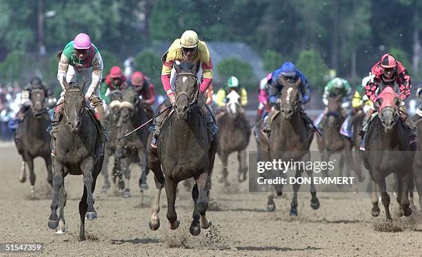 Jockey Kent Desormeaux leads the pack to the finish line aboard Fusaichi Pegasus to win the 126th Kentucky Derby 06 May 2000 at Churchill Downs in...