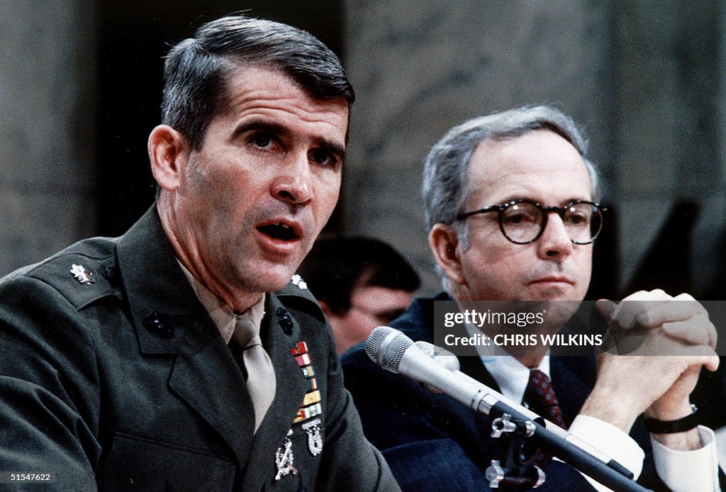 Lt. Col. Oliver North (L), accompanied by his lawy
