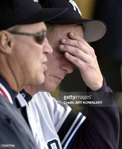New York Yankees pitcher David Cone holds his head while talking to pitching coach Mel Stottlemyre after pitching the seventh inning against the...