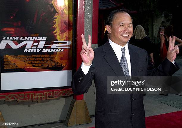 Director John Woo flashes the peace sign at the premiere of his new film "Mission Impossible 2" at the Chinese Theater in Hollywood, CA, 18 May 2000....