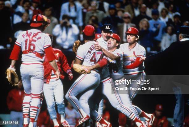 Joaquin Andujar of the St. Louis Cardinals is restrained by coach Nick Leyva after his meltdown and ejection in game 7 against the Kansas City Royals...