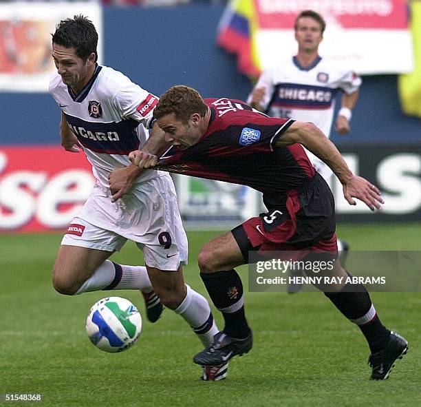 Chicago Fire's Ante Razov grabs the jersey of the MetroStars' Steve Jolley while chasing the ball in the first half of their Major League Soccer game...