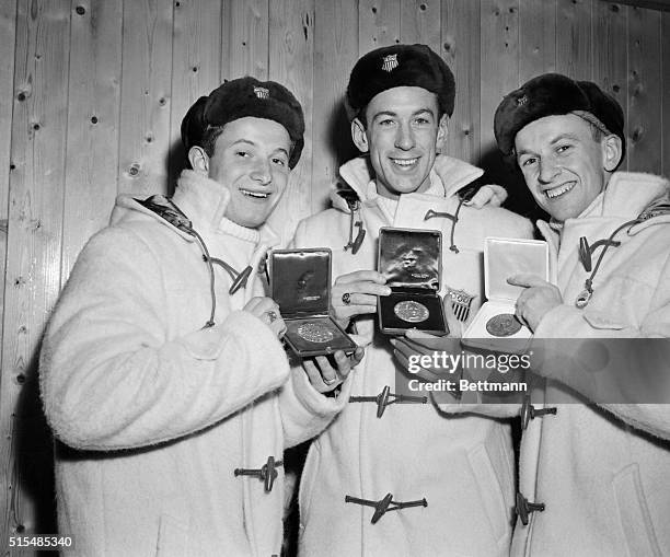 Jubilant American figure skaters Ronnie Robertson, Hayes Allen Jenkins, and his young brother David Jenkins, from left to right, proudly show the...