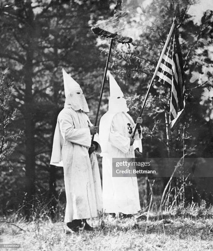 Two Ku Klux Klansmen with American Flag and Burning Cross