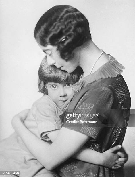 Dorothy 'Daphne' Milne, wife of British writer A. A. Milne, hugging their son, Christopher Robin, 1926.