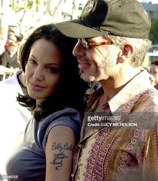 Actress Angelina Jolie shows off her new tattoo as she arrives at the premiere of her new film "Gone in 60 Seconds" with her new husband...