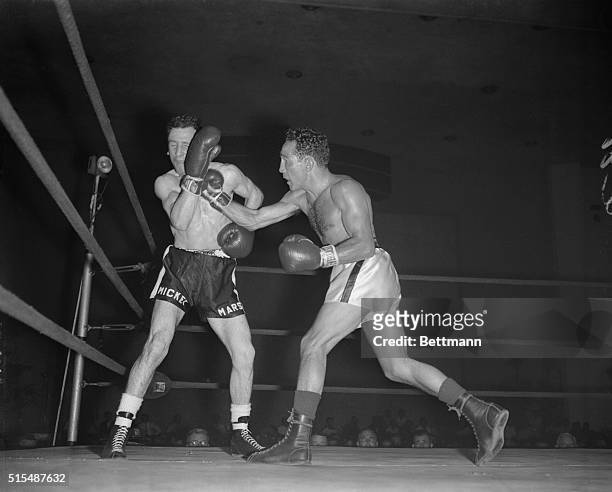 Willie Pep, former featherweight champ from Hartford, Conn., lands a left to the jaw of Andy Arel of Messena, N.Y., during the ninth round of their...