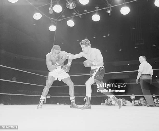 Jimmy Carter, left, former lightweight champion, winces from right hand blown by Cisco Andrade during the first round of their scheduled 10 round...