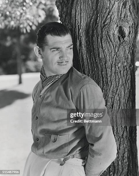 Clark Gable, Metro Goldwyn Mayer star, in an informal pose on the grounds of his home.