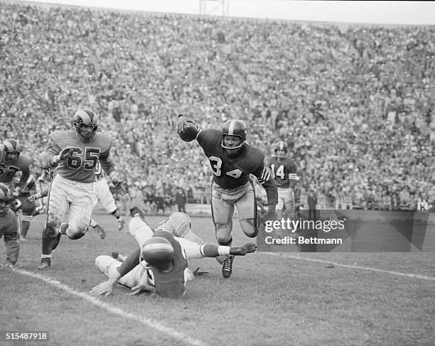Los Angeles Ram end Bob Boyd couldn't put conventional tackle on 49er fullback Joe Perry when he was blocked by 49er Gordy Soltau so he stuck out...