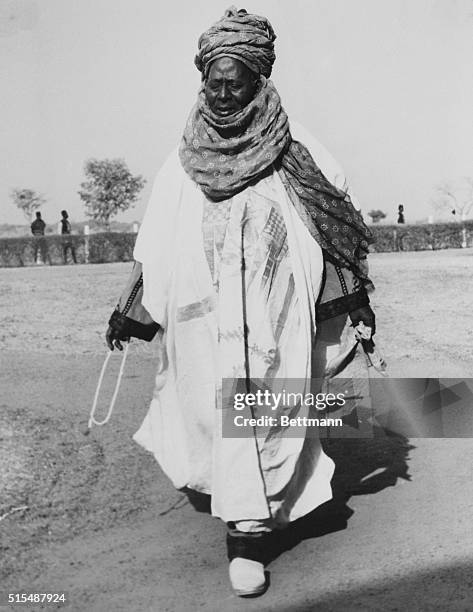 Member of the Northern Nigerian House of Assembly arrives at a meeting with Queen Elizabeth II and her husband Philip, Duke of Edinburgh.