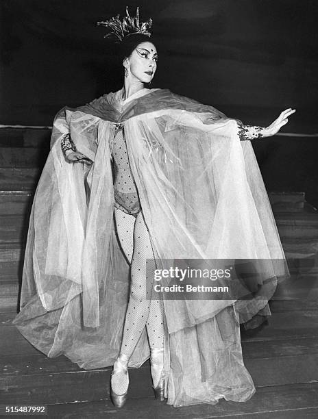 London, England- Dame Margot Fonteyn, who recently acquired her title, wears this striking costume in a scene from a new production of the ballet "La...