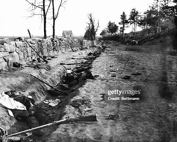 Rifles and bodies of Confederate soldiers lay strewn along the ground of Maryes Heights following the Battle of Chancellorsville in Fredericksburg,...