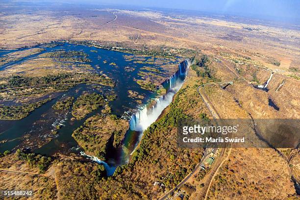 aerial victoria falls with rainbow, livingstone, zambia/zimbabwe - ビクトリアフォールズ町 ストックフォトと画像