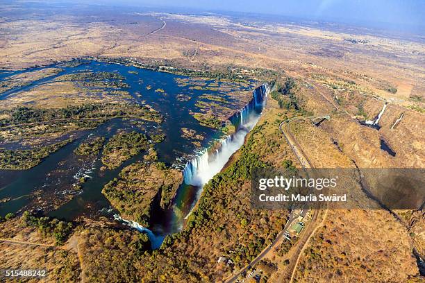 aerial victoria falls with rainbow, livingstone, zambia/zimbabwe - zimbabwe stock pictures, royalty-free photos & images