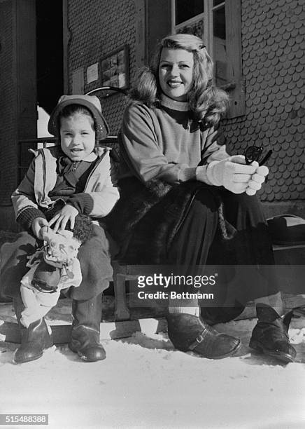Wonder What's Become of Aly? Murren, Switzerland: Beautiful Rita Hayworth and her daughter Rebecca make a happy-looking couple as they sit on a sled...