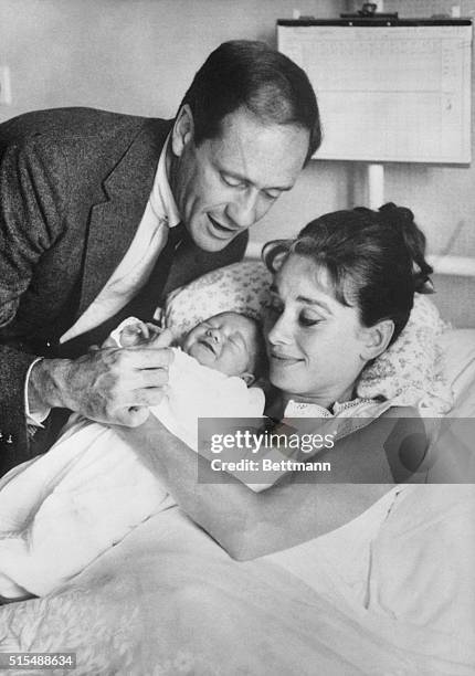 Film actress Audrey Hepburn and her husband, actor Mel Ferrer, proudly show off their baby son, Sean, here July 19th. The nine pound youngster was...