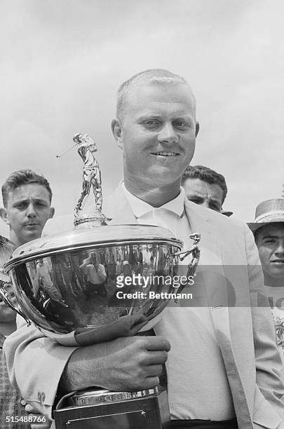 Flint, Michigan: Jack Nicklaus, Columbus, Ohio, holds trophy awarded to him for lowest scoring amateur golfer at the Buick Open golf tournament.