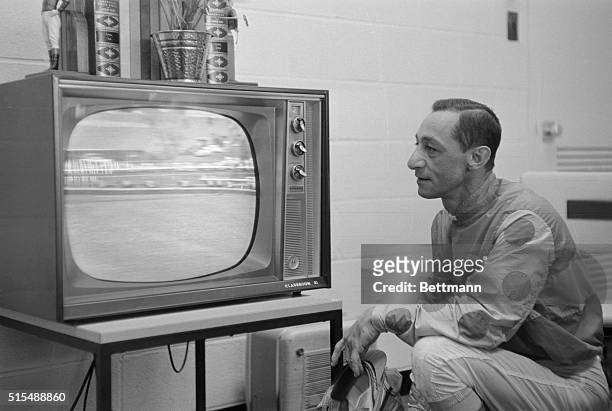 Jockey Eddie Arcaro takes a busman's holiday here May 7th as he watches the 86th running of the Kentucky Derby in Churchill Downs on a TV set between...