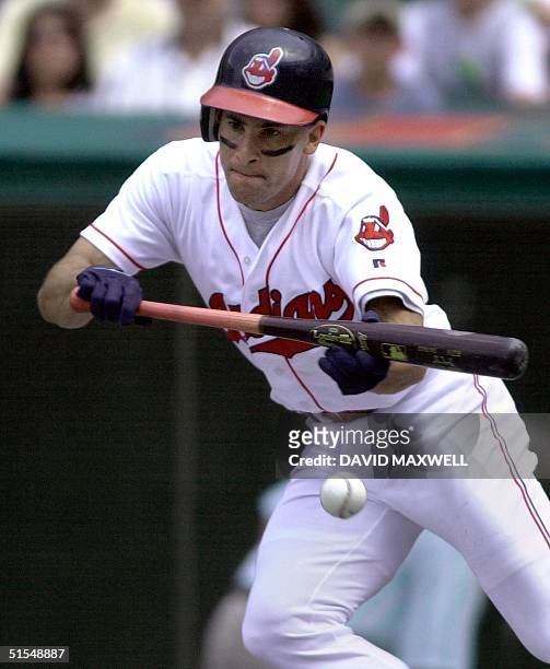 Cleveland Indians' short stop Omar Vizquel lays down a bunt single to lead off the fifth inning against the Cincinnati Reds 10 June, 2000 at Jacobs...