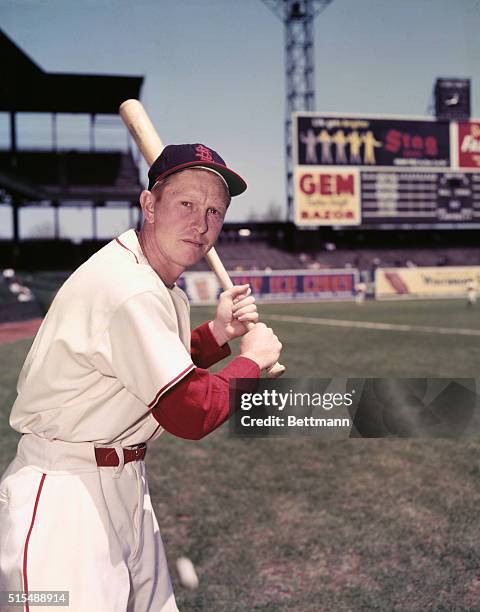 Left fielder Red Schoendist poses in uniform with bat.