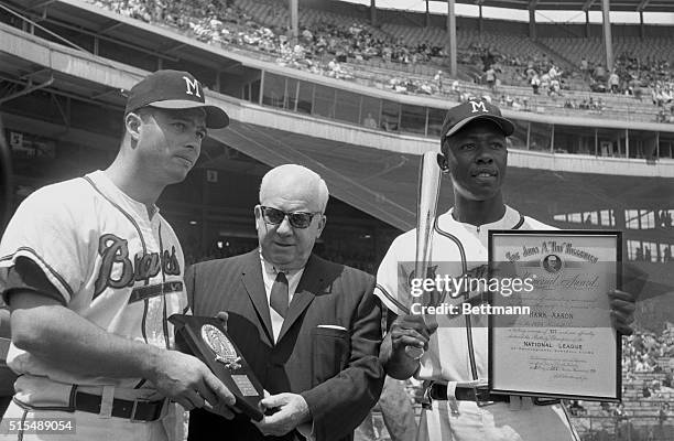 Milwaukee Braves third baseman Ed Mathews and right fielder Hank Aaron received awards before the Braves-Chicago Cubs game here. They are shown with...