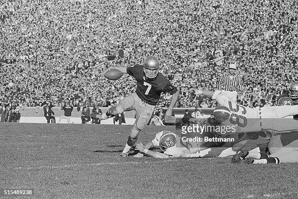 On Way to Score. South Bend, Indiana: Notre Dame quarterback John Huarte keeps the ball and leaps past Michigan State defenders Donald Bierwoicz and...